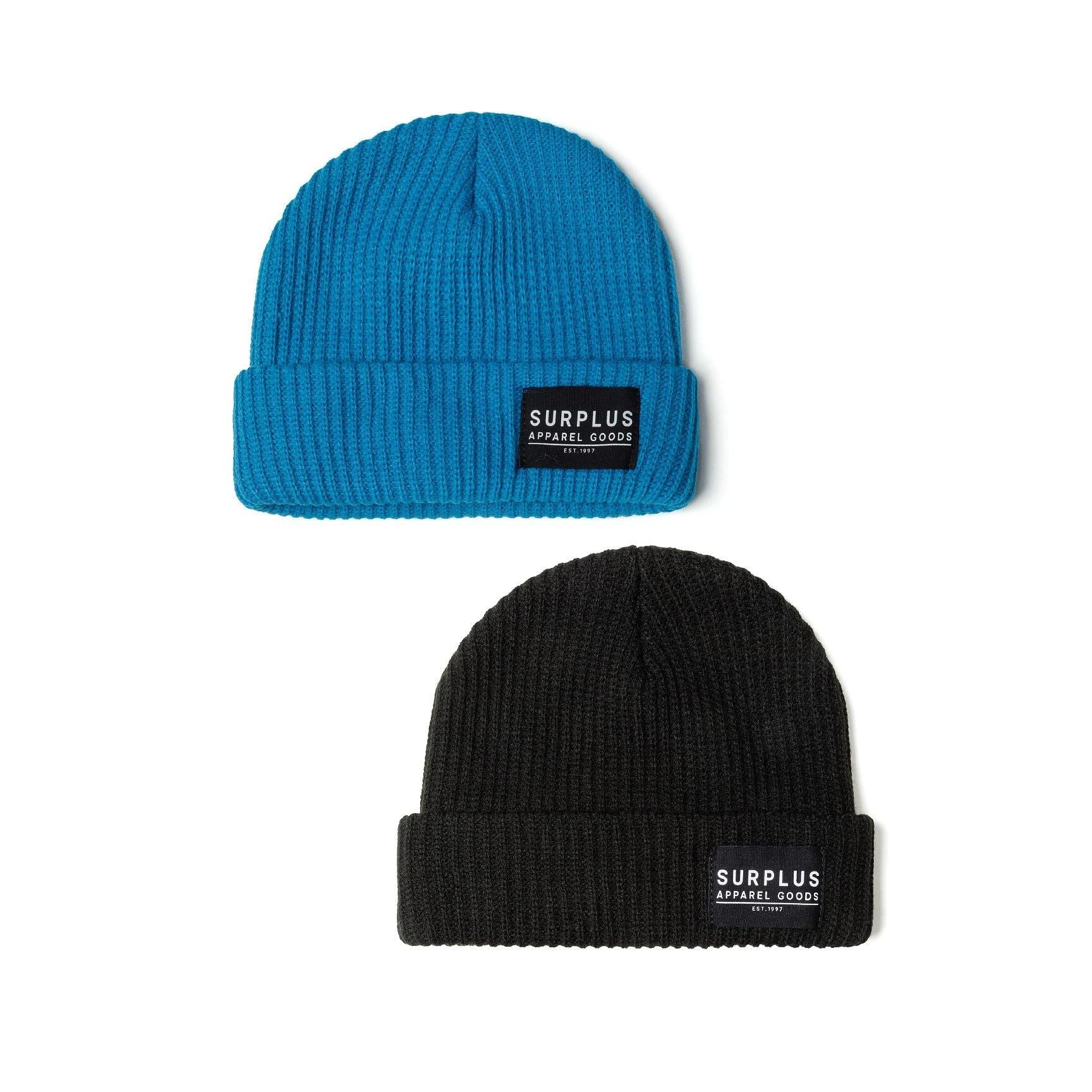Two ribbed knit beanies displayed on white background, one turquoise and one black, both featuring SURPLUS APPAREL GOODS labels