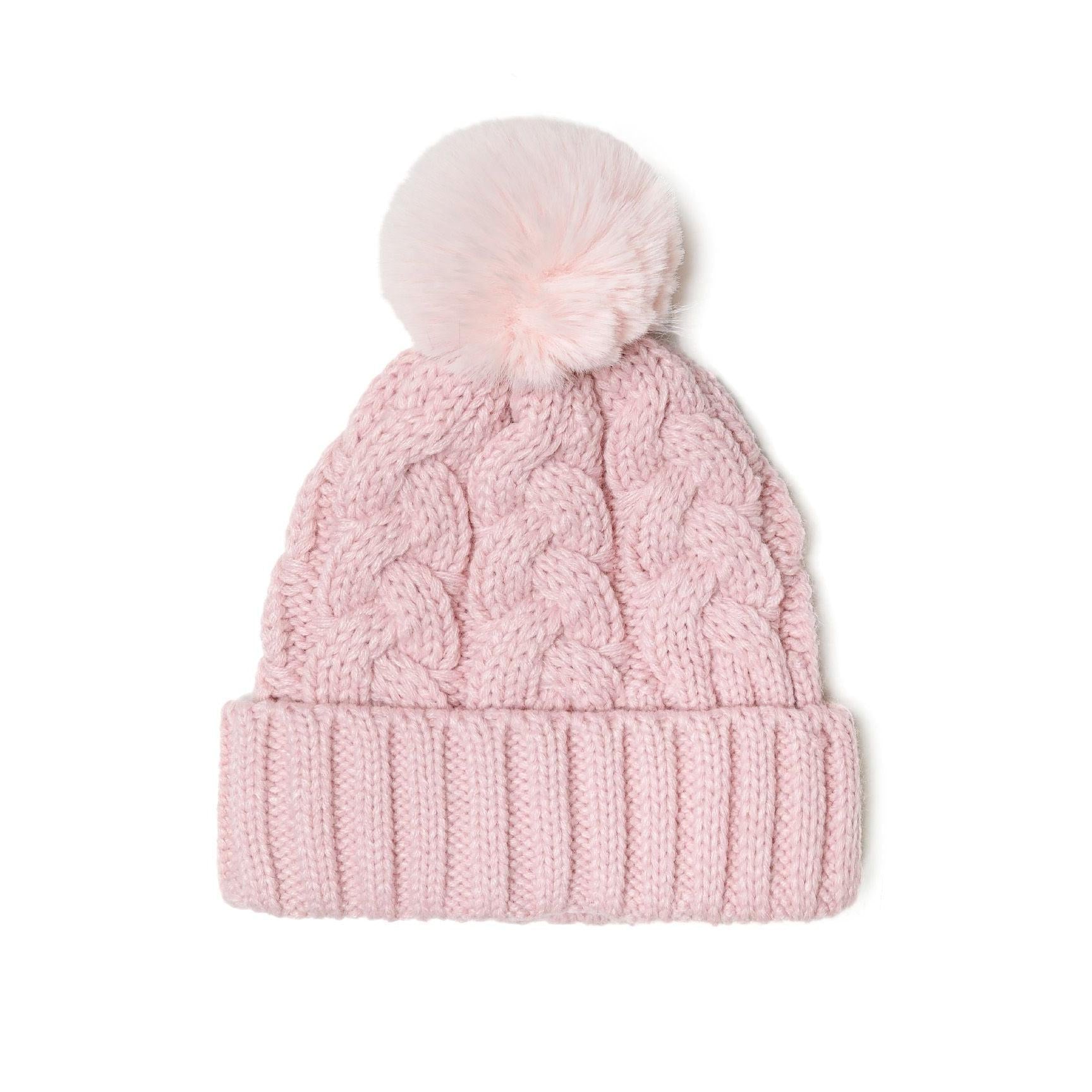 Close-up detail of light pink cable knit hat showing texture pattern and fluffy pom pom attachment