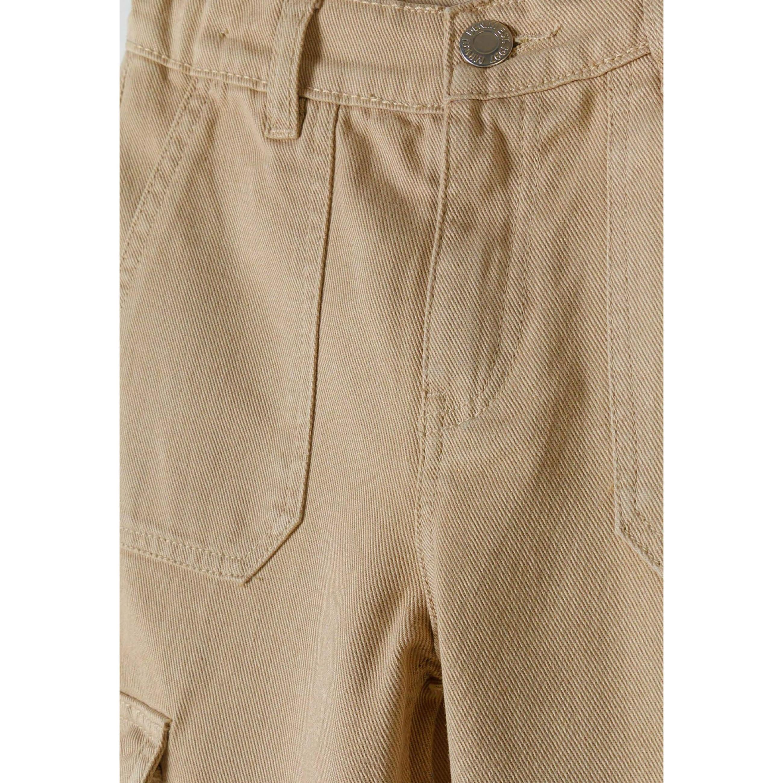 Close-up detail of beige cargo trousers showing front cargo pocket and soft twill fabric texture