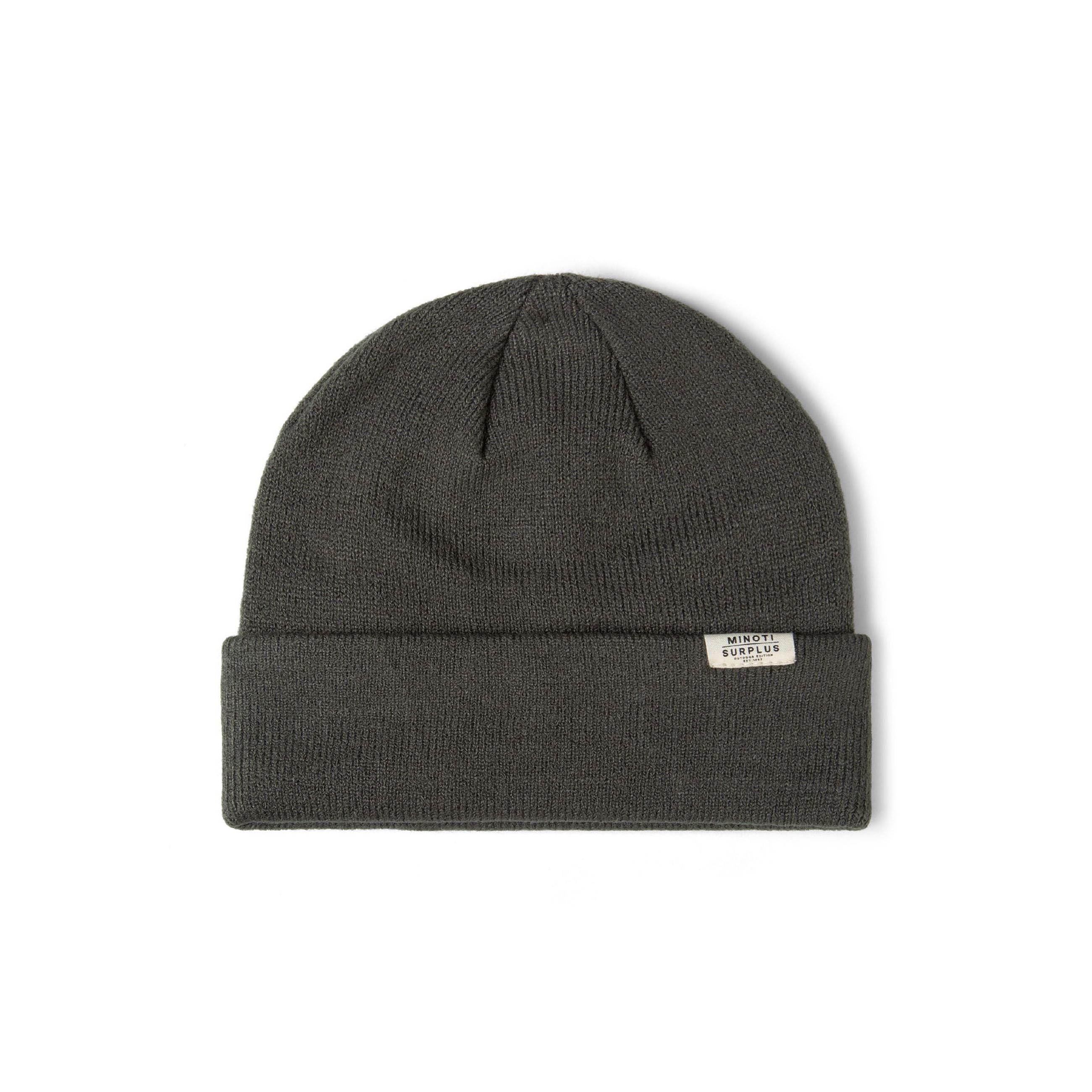 Close-up detail of cream ribbed beanie showing Minoti Surplus woven label and soft knit texture on white background