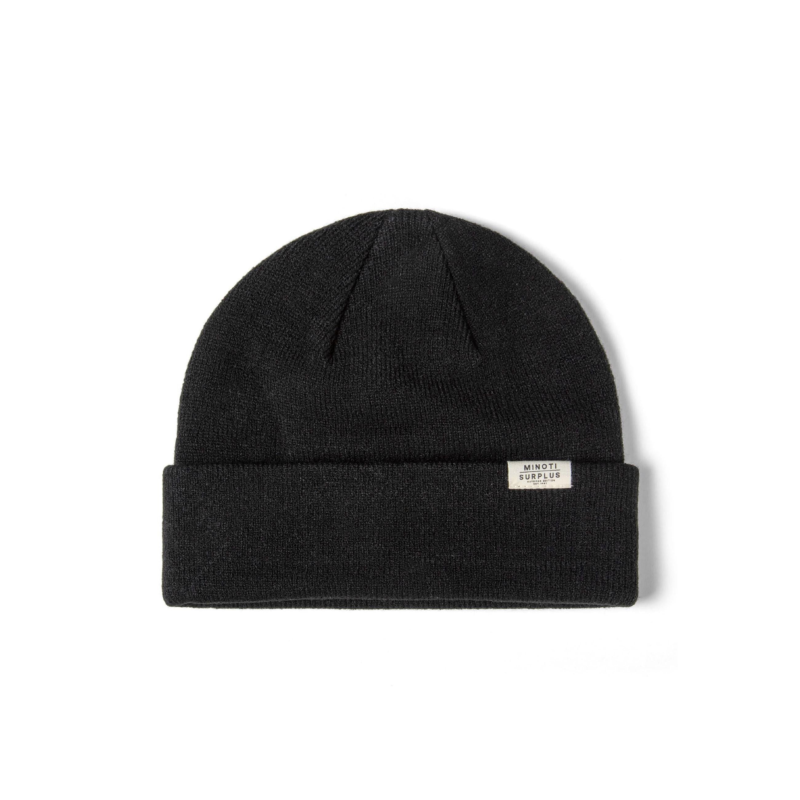 Close-up detail of cream ribbed beanie showing Minoti Surplus woven label and soft knit texture on white background