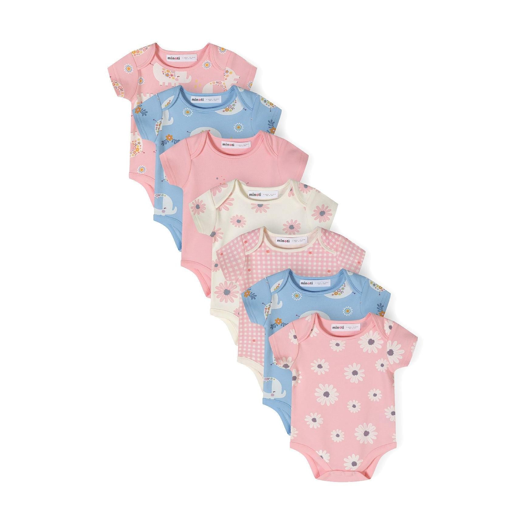Stack of seven short sleeve bodysuits in light pink shades featuring various prints including elephants, daisies, gingham and floral patterns arranged in a fan display on white background
