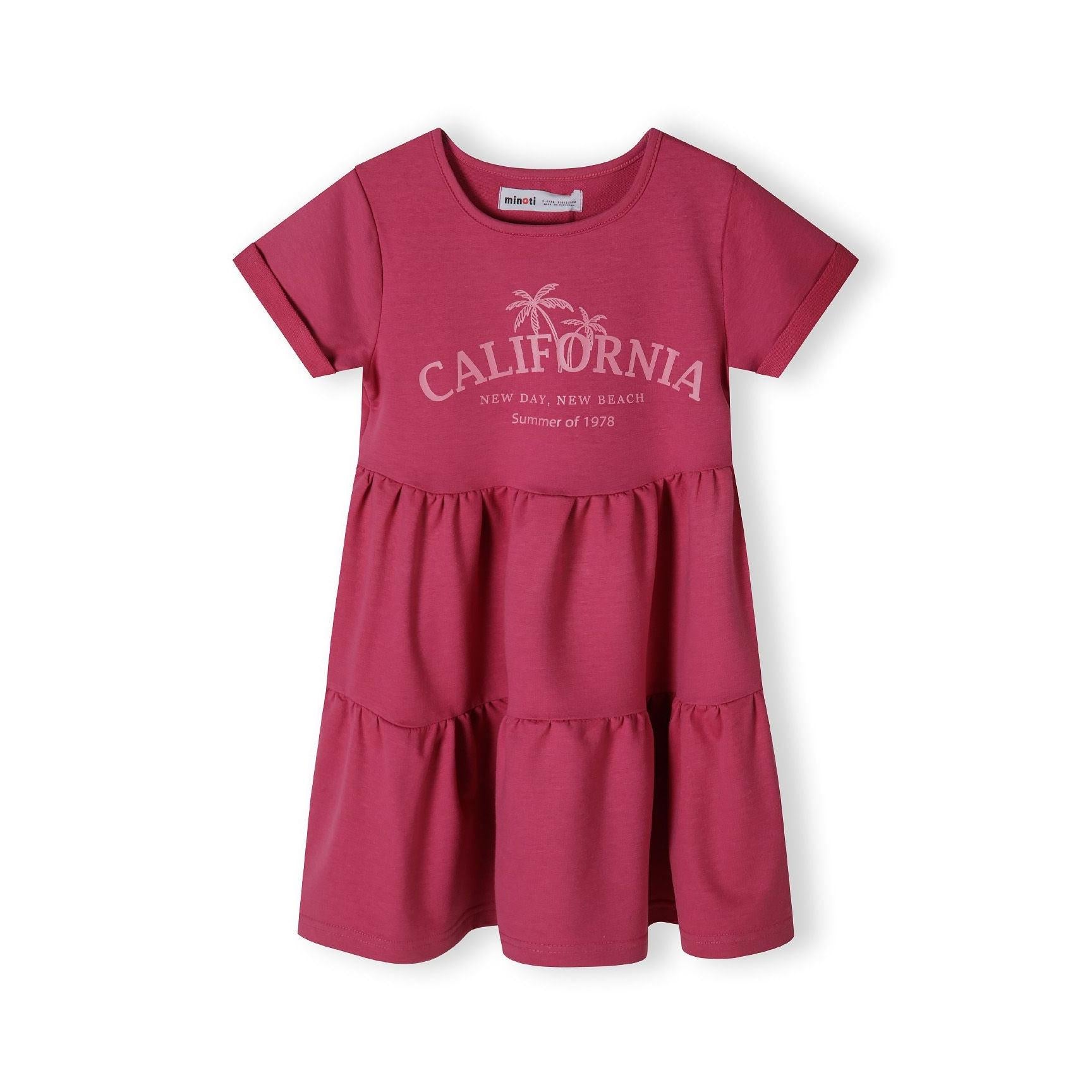 Back view of pink cotton fleece dress showing tiered construction and flowing silhouette on white background