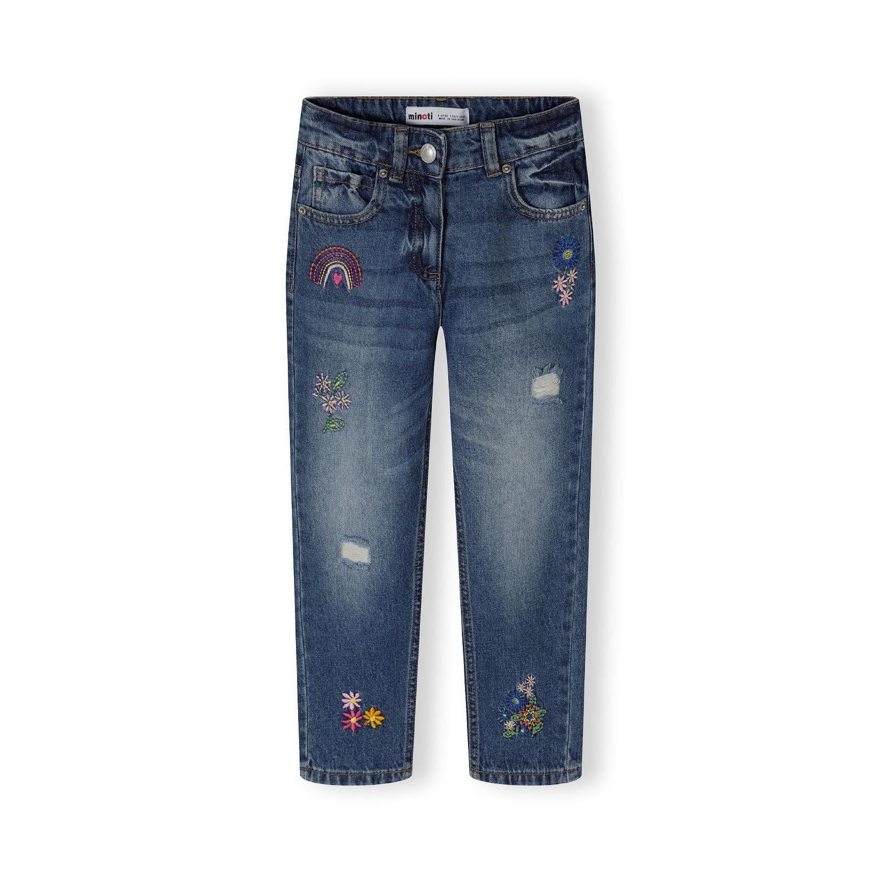 Back view of navy denim jeans showing embroidered rainbow and floral details on pockets against white background