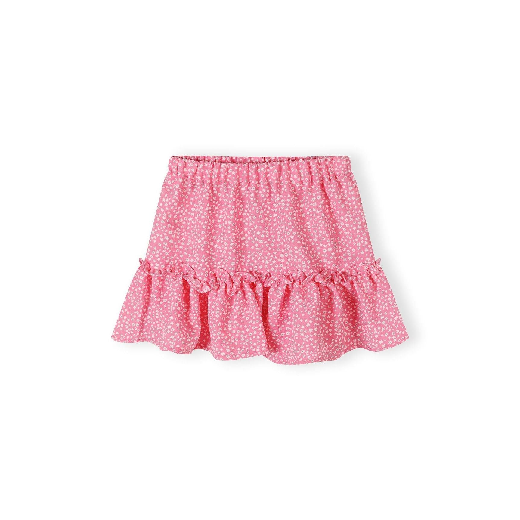 Pink crinkle layered skirt with white floral pattern laid flat showing pleated ruffle hem and elastic waistband on white background