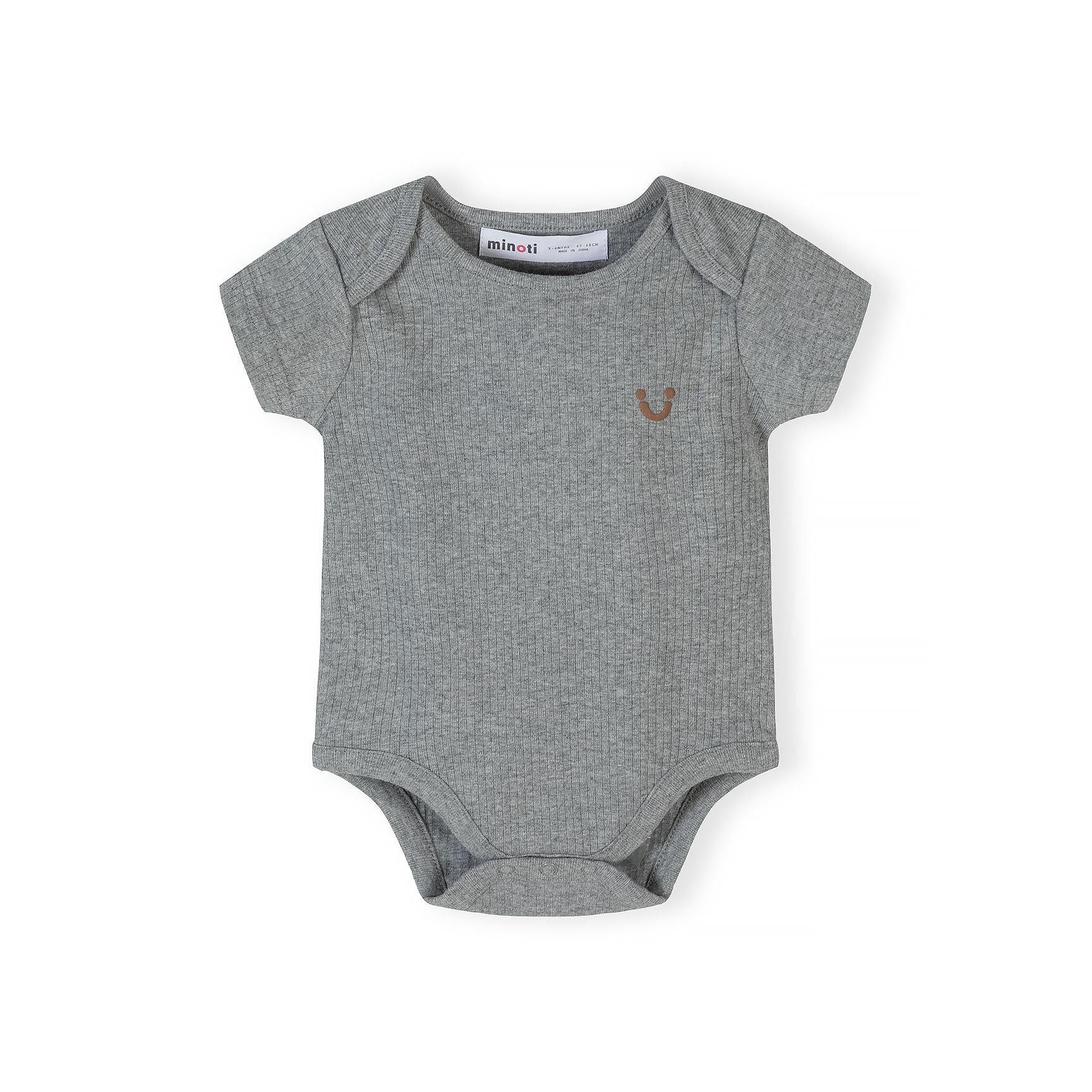 Close-up of beige ribbed bodysuit with black polka dot pattern and Minoti brand label visible at neckline