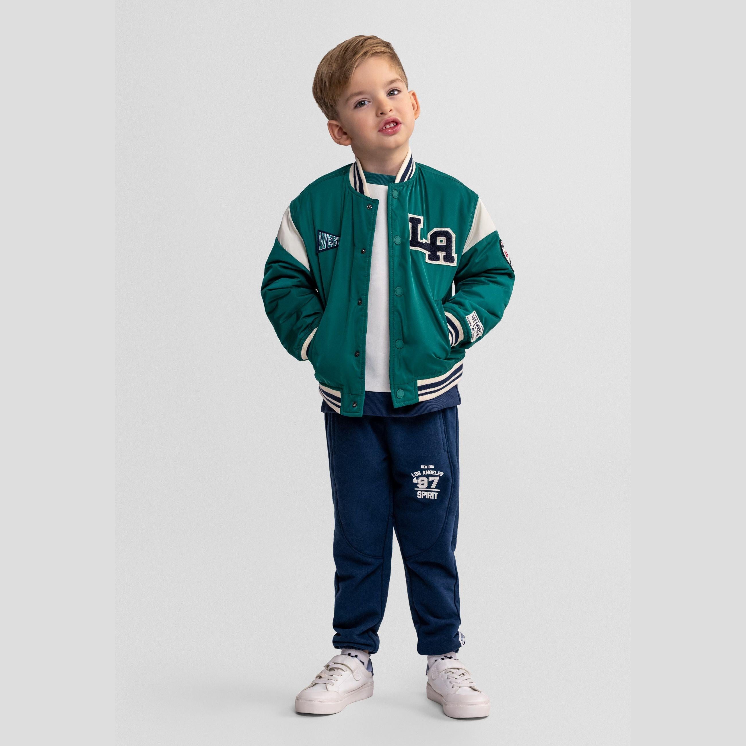 Green varsity bomber jacket laid flat showing front view with LA patch, WEST patch, and cream contrast sleeves