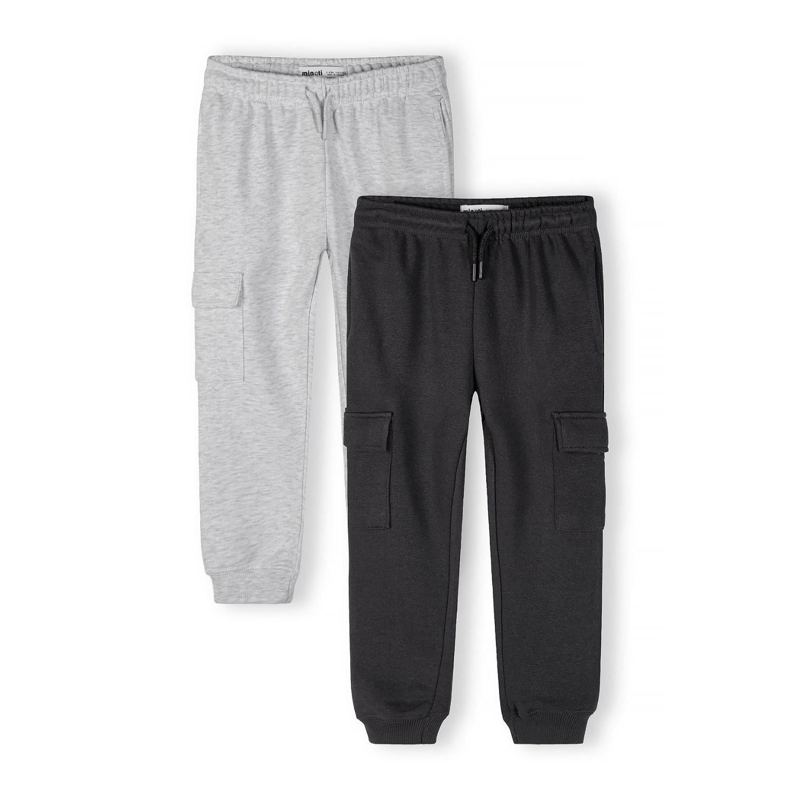 Black cargo joggers flat lay on white background showing functional side cargo pockets and elastic waistband detail