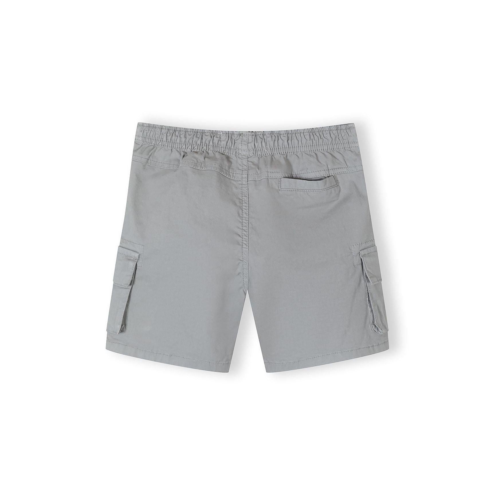 Close-up detail of grey shorts waistband showing black and white striped drawstring with metal eyelets and elastic waist construction