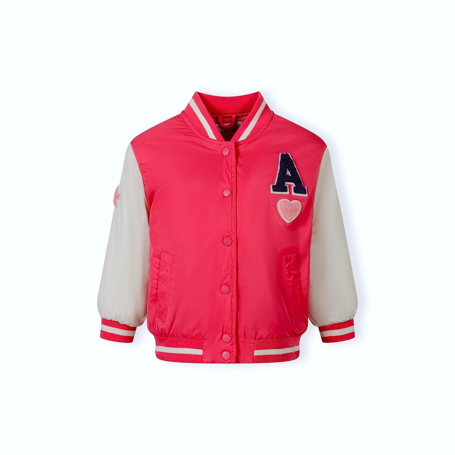 Close-up detail of pink varsity bomber jacket showing side pocket and ribbed trim construction