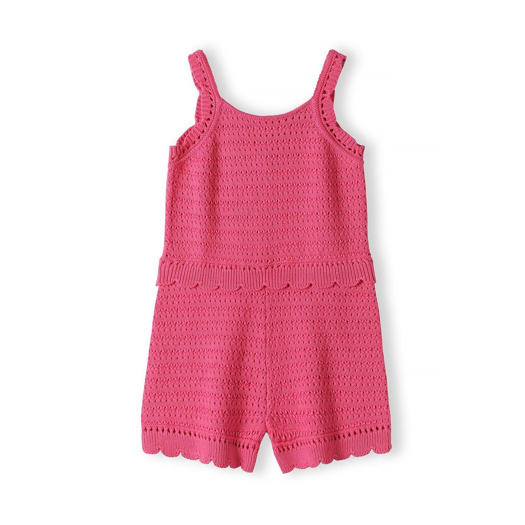 Pink crochet jumpsuit with intricate lacework pattern, adjustable straps and scalloped hem edges displayed on white background