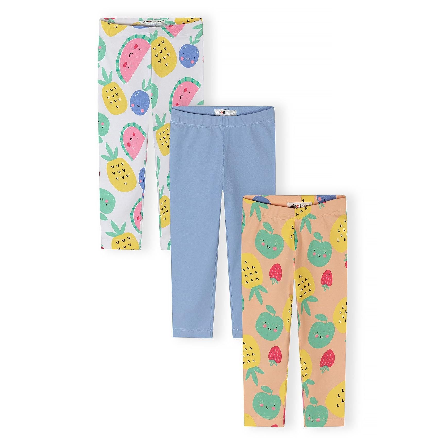 Three capri leggings laid flat showing white with colorful fruit print, solid blue, and peach with fruit pattern on white background