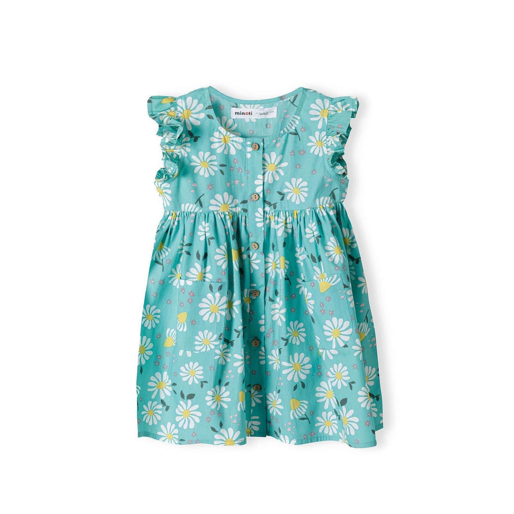 Flat lay of turquoise dress with white daisy print showing frilled sleeves and full silhouette on white background