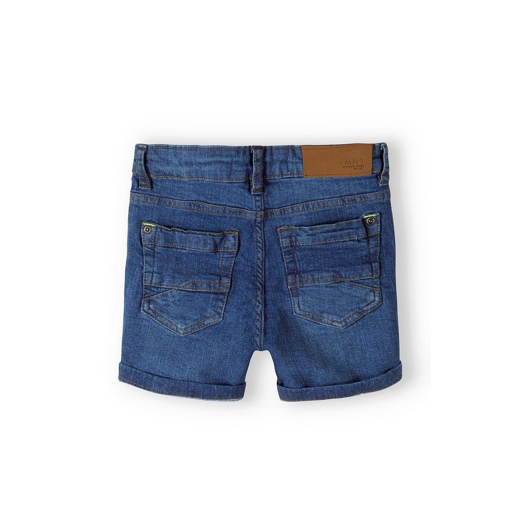 Back view of navy denim shorts showing rear pockets with brown leather waistband label on white background
