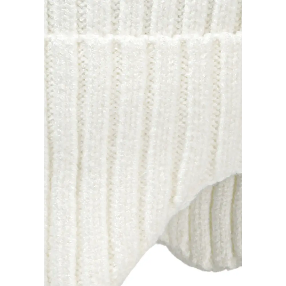 Detail shot of pink beanie showing fluffy dusty pink pom pom and ribbed knit texture with ear flap construction