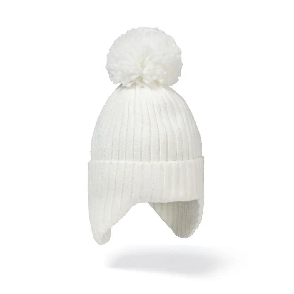 Close-up view of cream white ribbed knit beanie with large fluffy white pom pom and ear flaps against white background