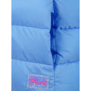 Close-up of a light blue quilted gilet with a side pocket and a glittery brand tag.