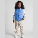 Smiling girl in light blue quilted gilet with detachable hood, full zip, and side pockets.