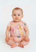 Baby girl wearing pink short sleeve bodysuit with colorful animal designs sitting on white background