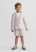 Young boy wearing a stone striped cotton blazer with notch collar and matching shorts, smiling confidently in kids fashion.
