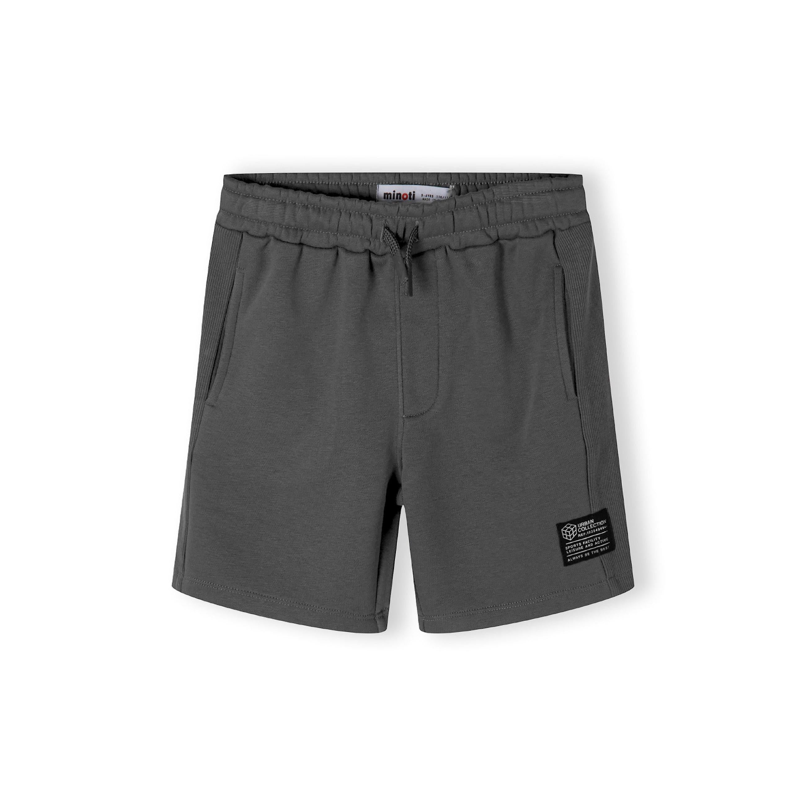 Grey fleece shorts laid flat showing elastic waistband and ribbed side panel details on white background