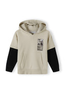 Boys hoodie in beige with black sleeves, front view, featuring a kangaroo pocket and graphic print.