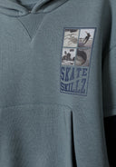 Boys hoodie in blue with a kangaroo pocket and graphic print, close-up view.