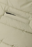 Detail of a boys padded gilet with chevron pattern and zip pocket.