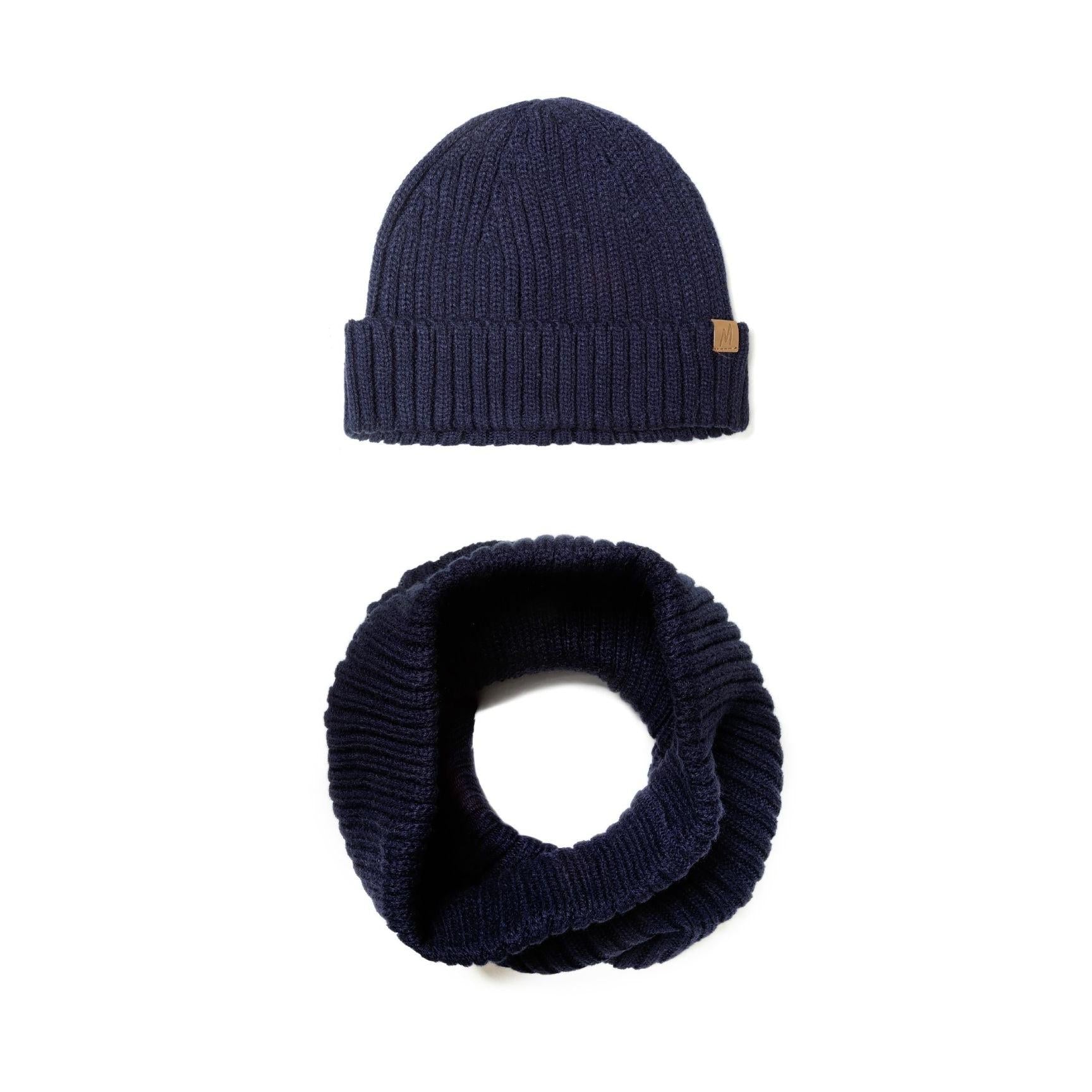 Close-up detail of navy ribbed beanie showing brown leather Minoti patch branding