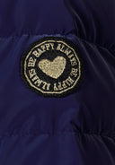 Close-up of a navy padded jacket sleeve featuring a distinctive embroidered badge.