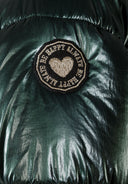 Detail of a green padded jacket with a logo badge.
