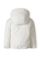 Back view of a girls' reversible jacket in soft plush teddy fur with a hood.