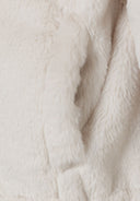 Detail of plush teddy fur in beige, showcasing soft texture.