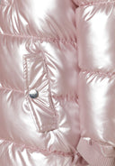 Detail of a shiny pink girls winter coat with a snap pocket and ribbed cuff.