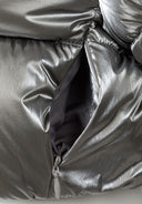 Detail of a grey metallic padded jacket showing a zippered pocket.
