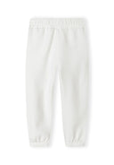 Detail of white joggers with elasticated waistband and ribbed ankle cuffs.