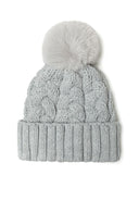 Girls knitted cable pom pom hat, grey, front view with ribbed edge.