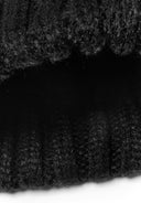 Detail of a black knitted cable pom pom hat for girls, showcasing the textured knit pattern.