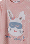 Detail of girls' pink long sleeve pyjama top with bunny design and polka dots.