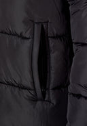 Detail of a black padded winter coat showing a zip pocket.