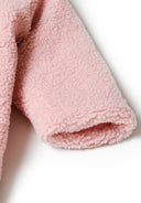 Detail of light pink baby snowsuit sleeve with soft sherpa fabric.