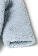 Detail of light blue baby snowsuit with soft sherpa fabric and ribbed cuff.