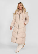 Women long quilted winter jacket in light beige with drawstring hood and zip, front view.