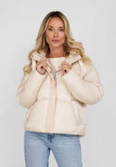 Women short padded jacket in light grey with a hood and curved stitching, front view.
