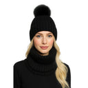 Close-up of a black knitted beanie with faux fur pom pom and matching snood.
