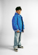 Boys baseball style jacket in cobalt blue, front view, features ribbed cuffs and detachable hood.