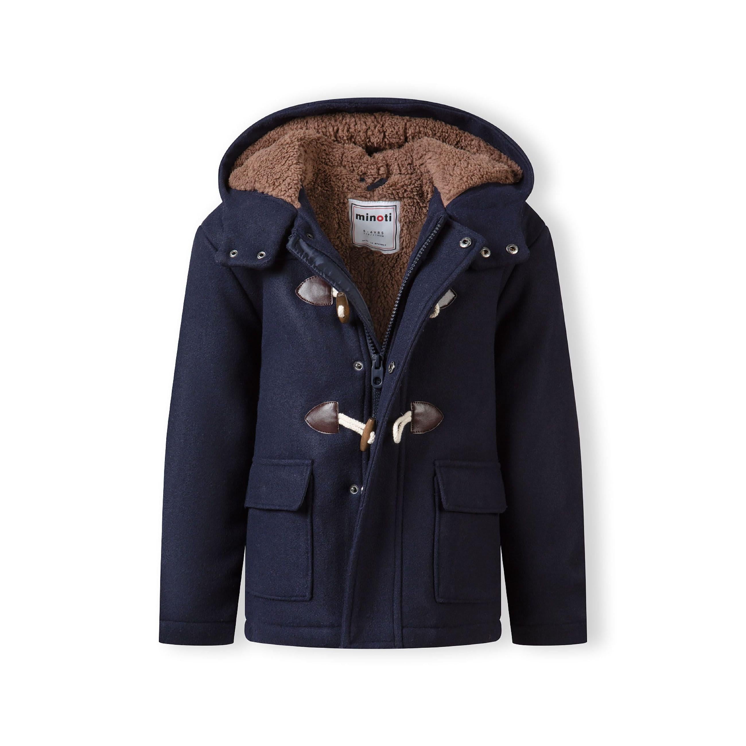 Close-up detail of navy duffle coat showing front patch pocket and toggle closure with brown leather-effect backing