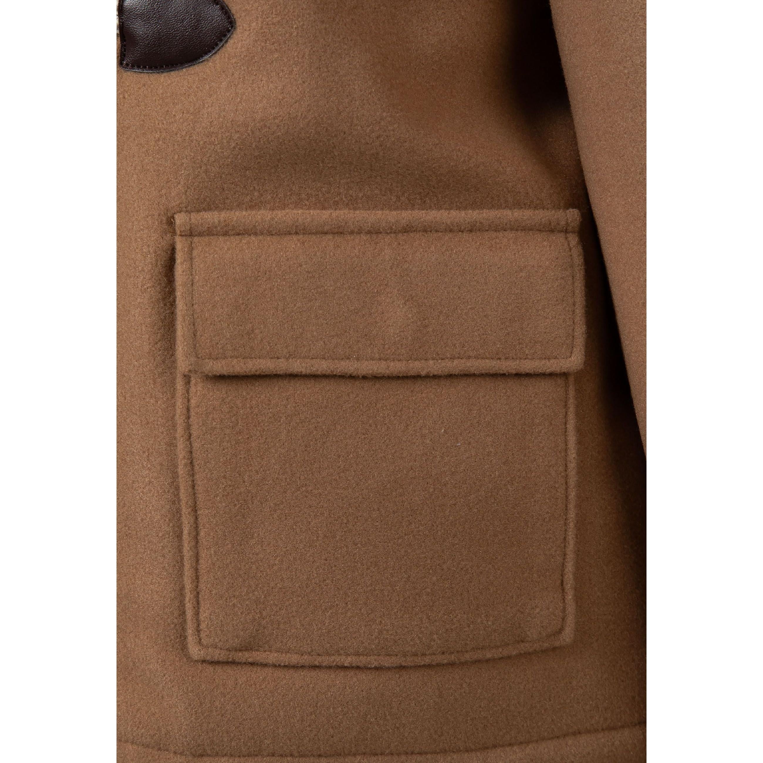 Close-up detail of beige duffle coat pocket with clean stitching and quality fabric texture