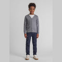 Young boy wearing a grey fine knit v-neck button-down cardigan over a white tee and navy pants.