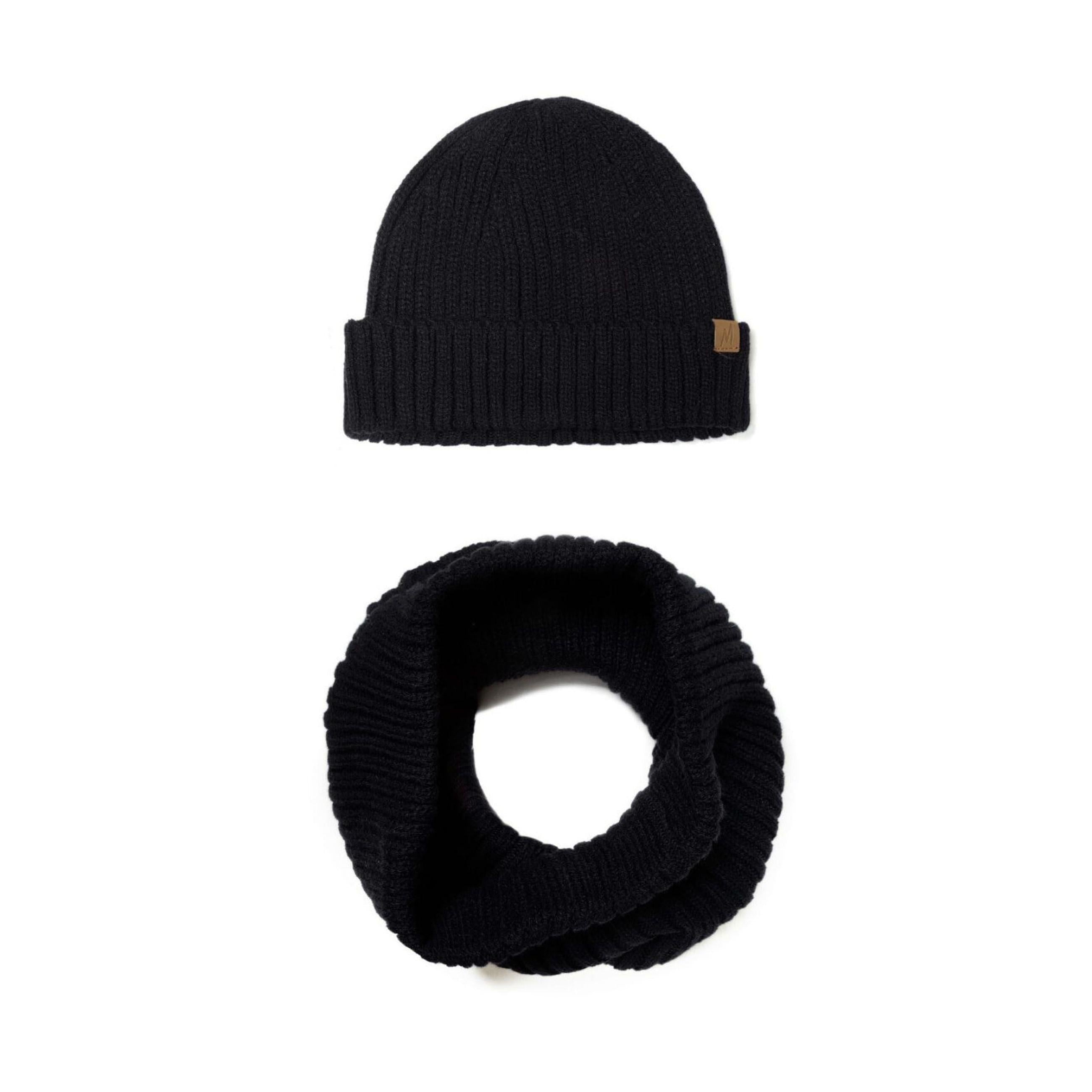 Black ribbed knit beanie displayed flat against white background showing fold-over cuff and brown M branded label